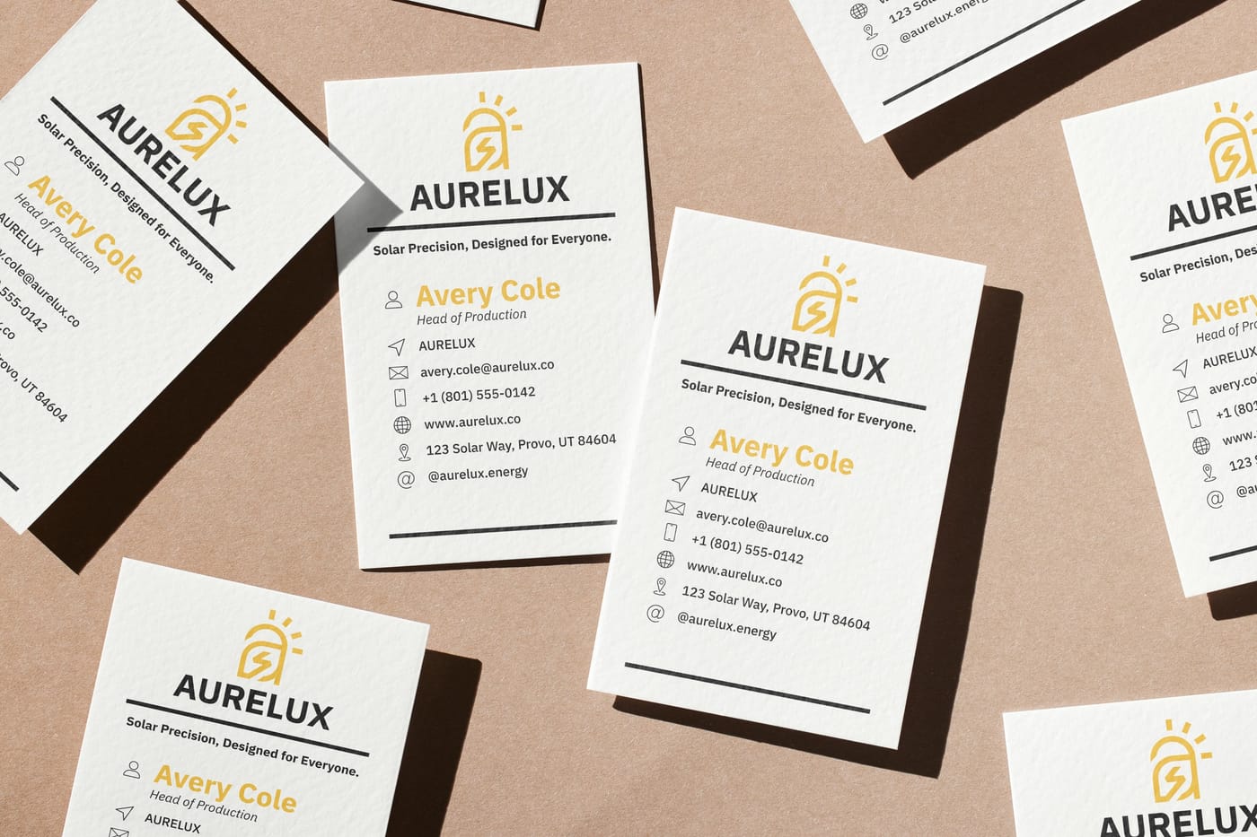 Aurelux business cards scattered on kraft paper.
