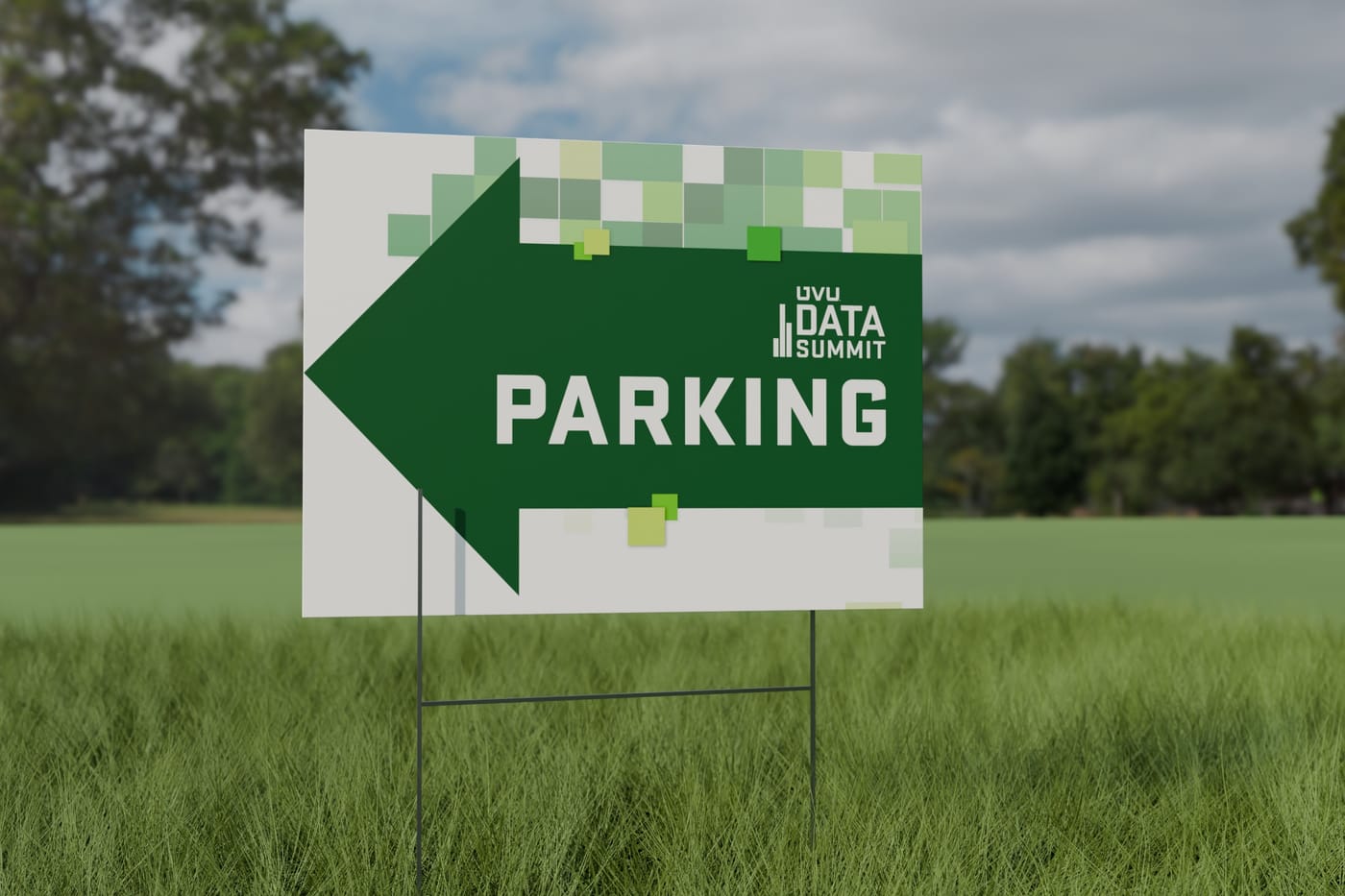 A Data Summit yard sign on a lawn: a dark green arrow pointing left with the word Parking, under a band of green pixel squares.
