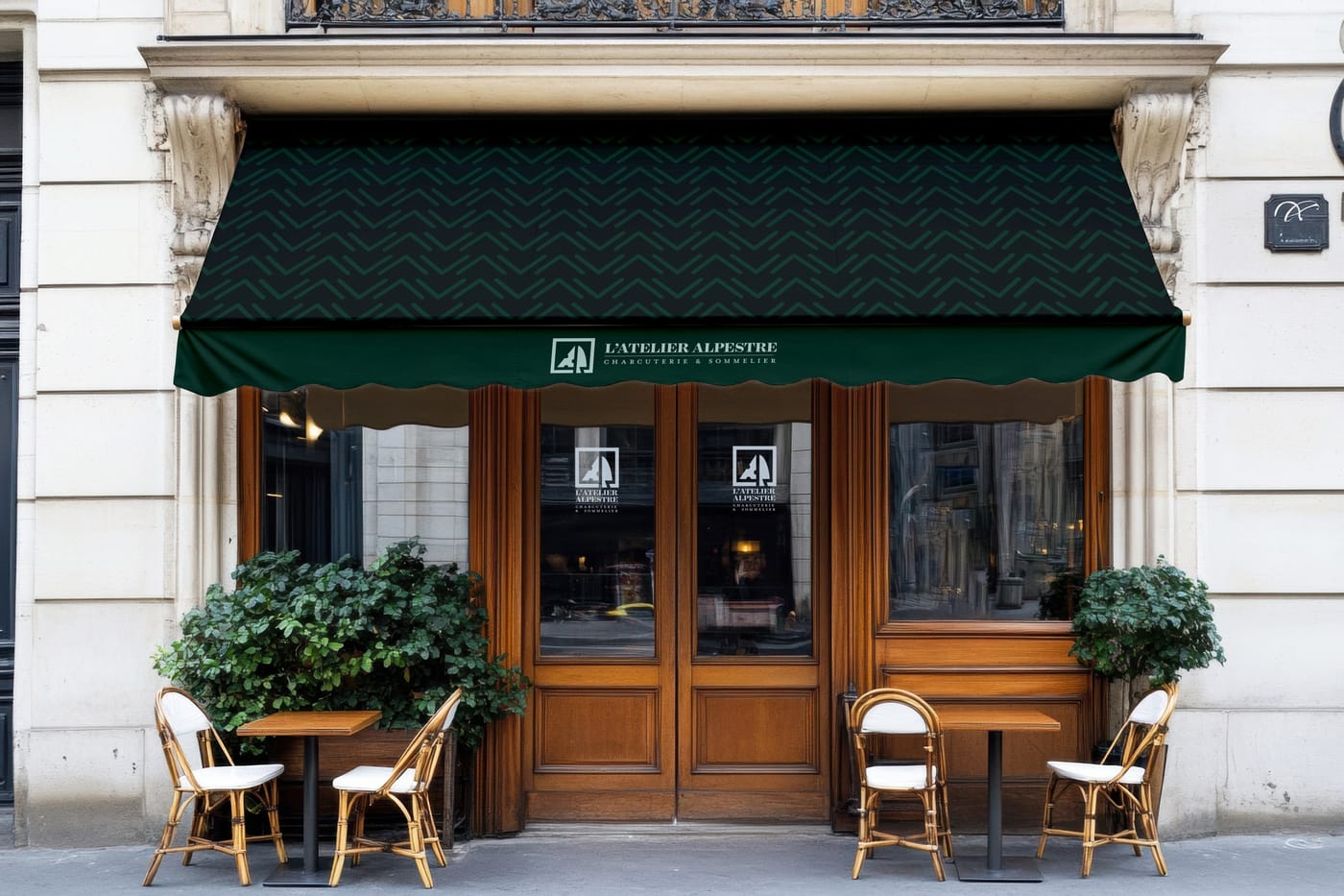 A storefront with a dark green awning carrying the L'Atelier Alpestre wordmark.