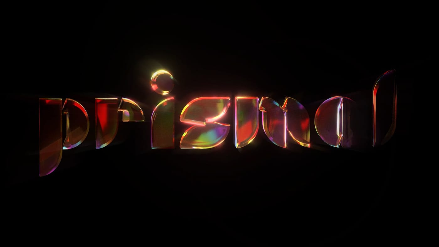 The word prismal in faceted glass letters glowing red, gold and violet with soft bloom on black.