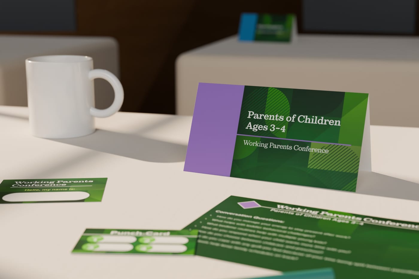 A lunch table set for the Parents of Children Ages 3–4 group: a purple-and-green tent card, conversation sheet, punch card and name badge beside a mug, in warm window light.